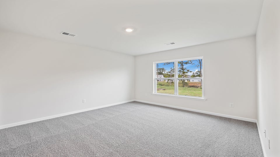 Bedroom with carpet and windows.