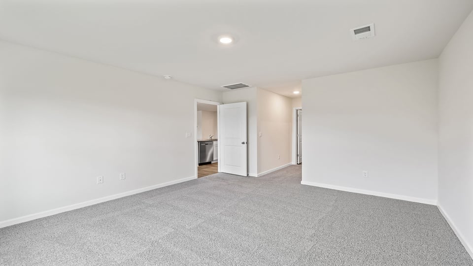 Bedroom with carpet and windows.
