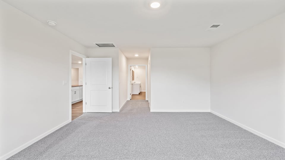 Bedroom with carpet and windows.