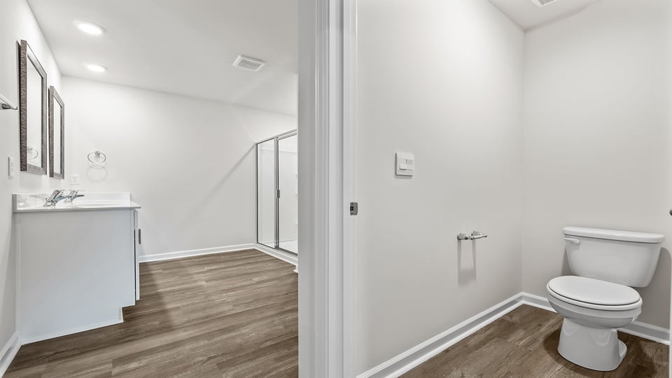 Bathroom with toilet and sinks.