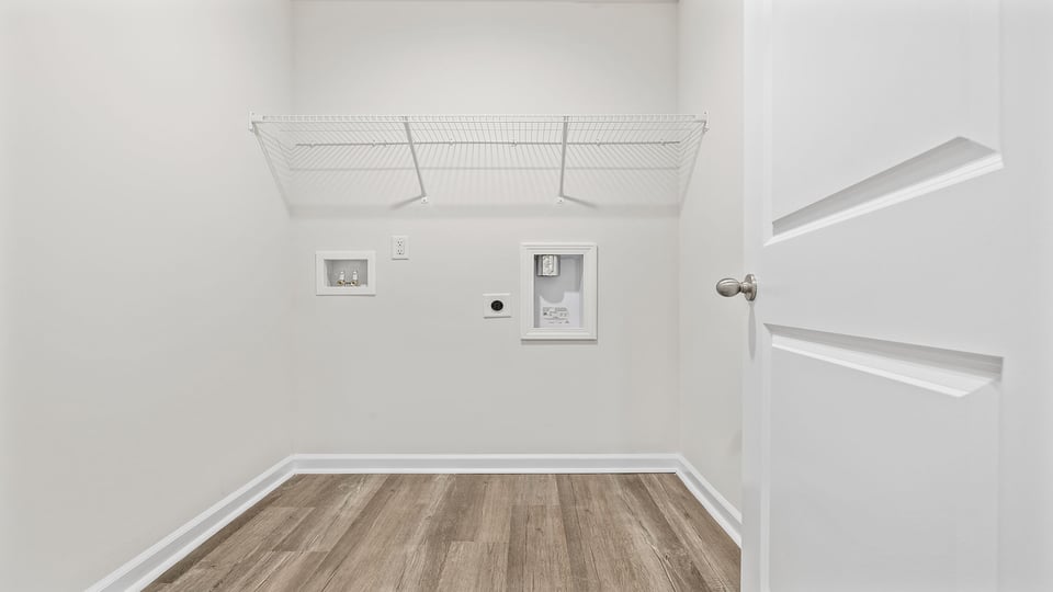 Laundry room with hanging storage racks.