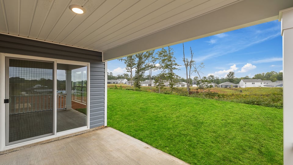 Back exterior of home with patio.