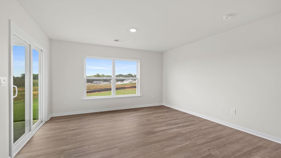 Dining room with windows and doors to outside.