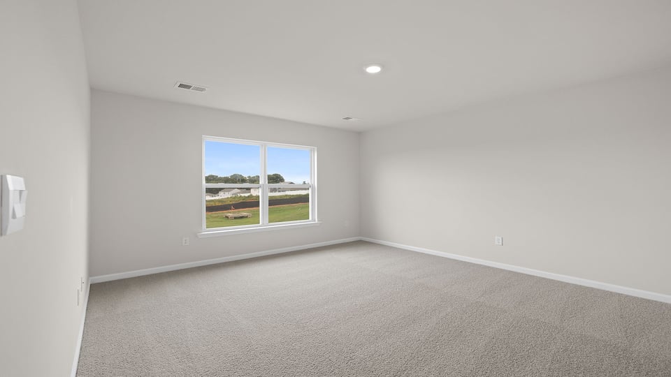 Bedroom with carpet and windows.