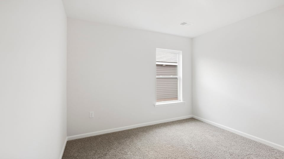 Bedroom with carpet and window.