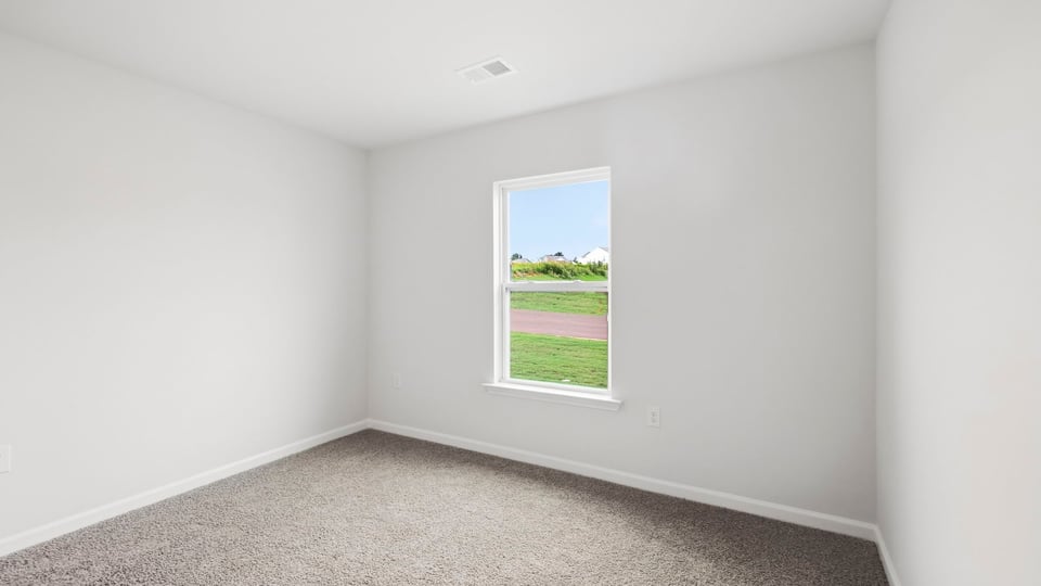 Bedroom with carpet and window.