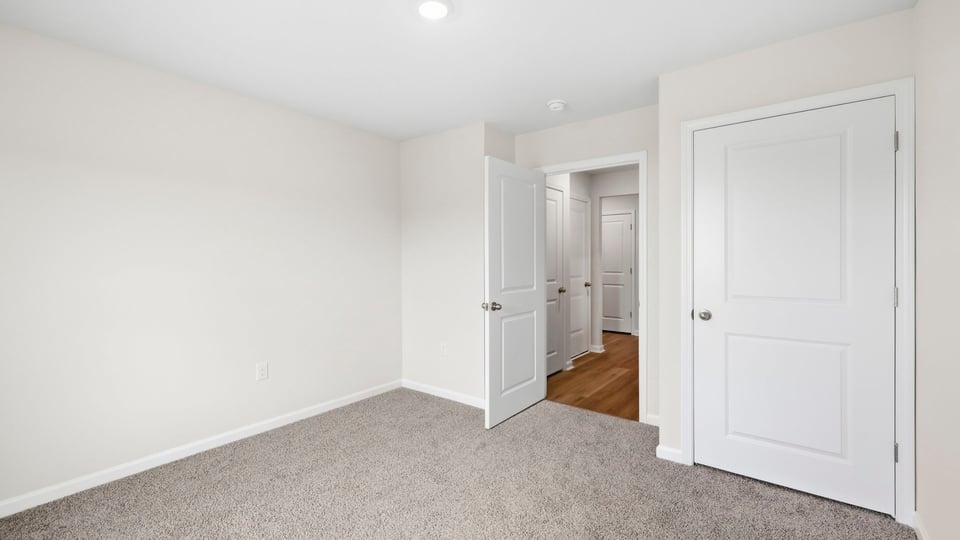 Bedroom with carpet and window.