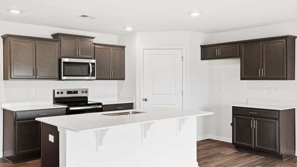 Kitchen with island and countertops.