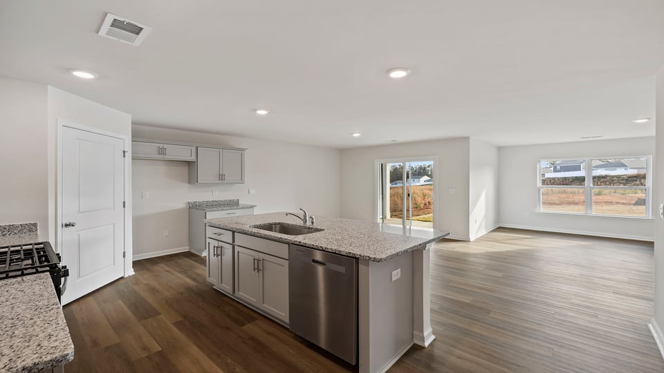 Kitchen and island with granite countertops.