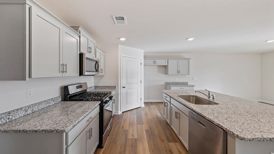 Kitchen and island with granite countertops.