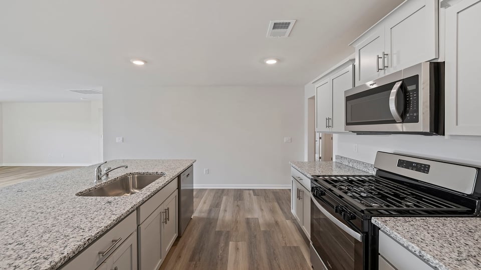 Kitchen and island with granite countertops.