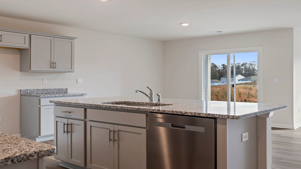 Kitchen and island with granite countertops.