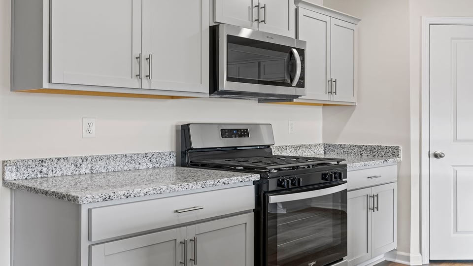 Kitchen with granite countertops and stainless steel appliances.