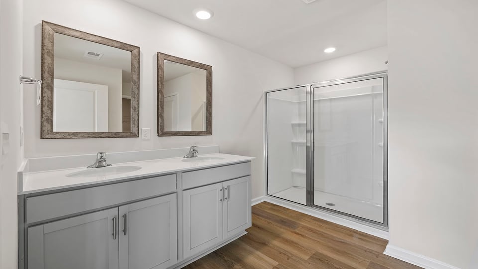 Bathroom with dual vanity and walk in shower.