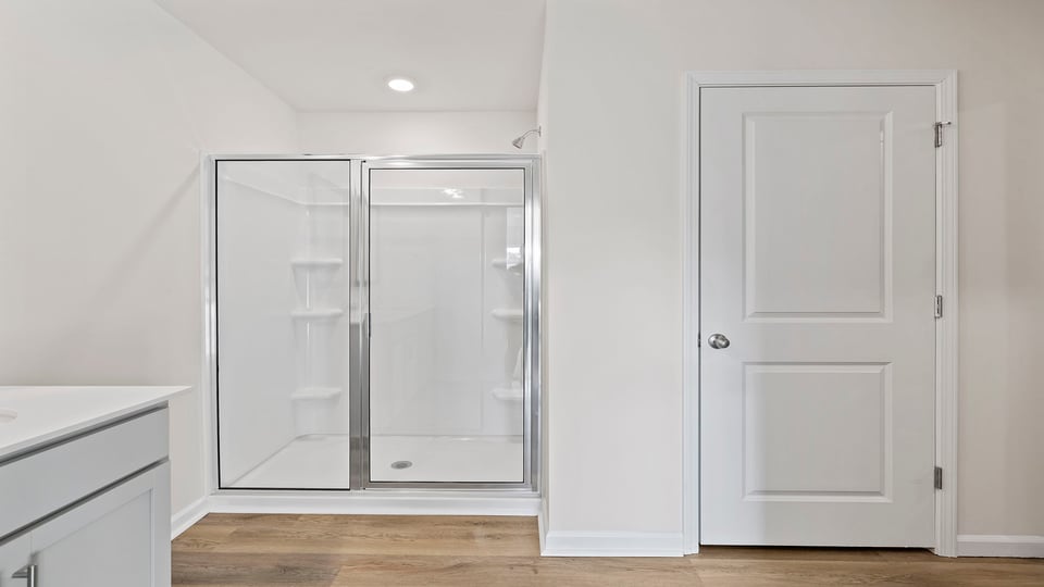 Bathroom with dual vanity and walk in shower.