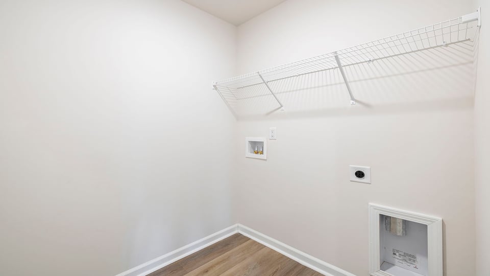 Walk in laundry with shelves.