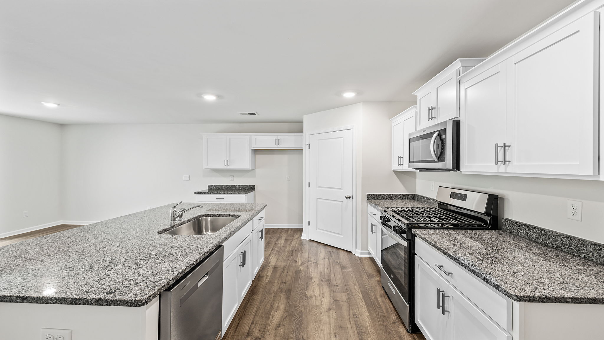 Kitchen with quartz countertops and stainless steel appliances.