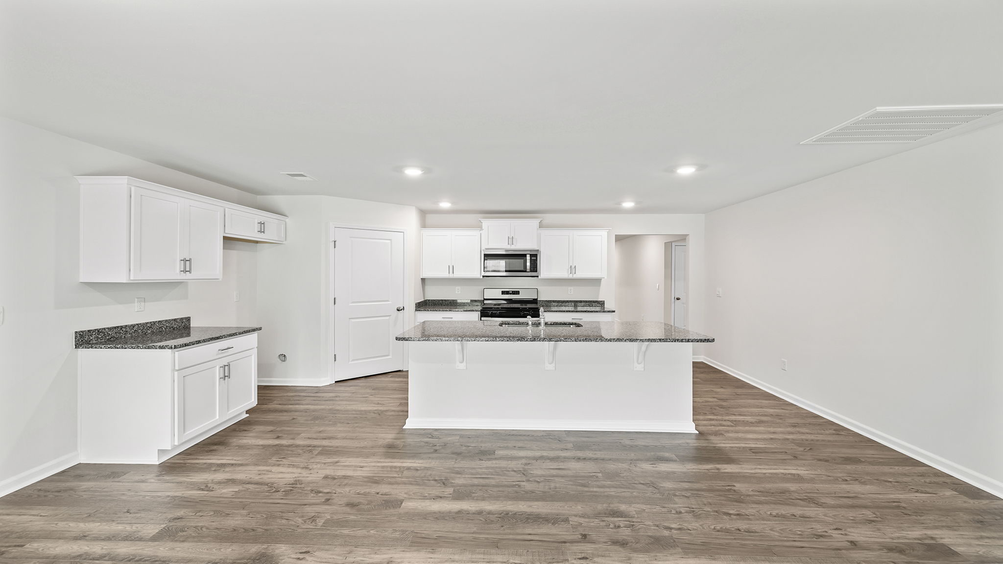 Kitchen with quartz countertops and stainless steel appliances.