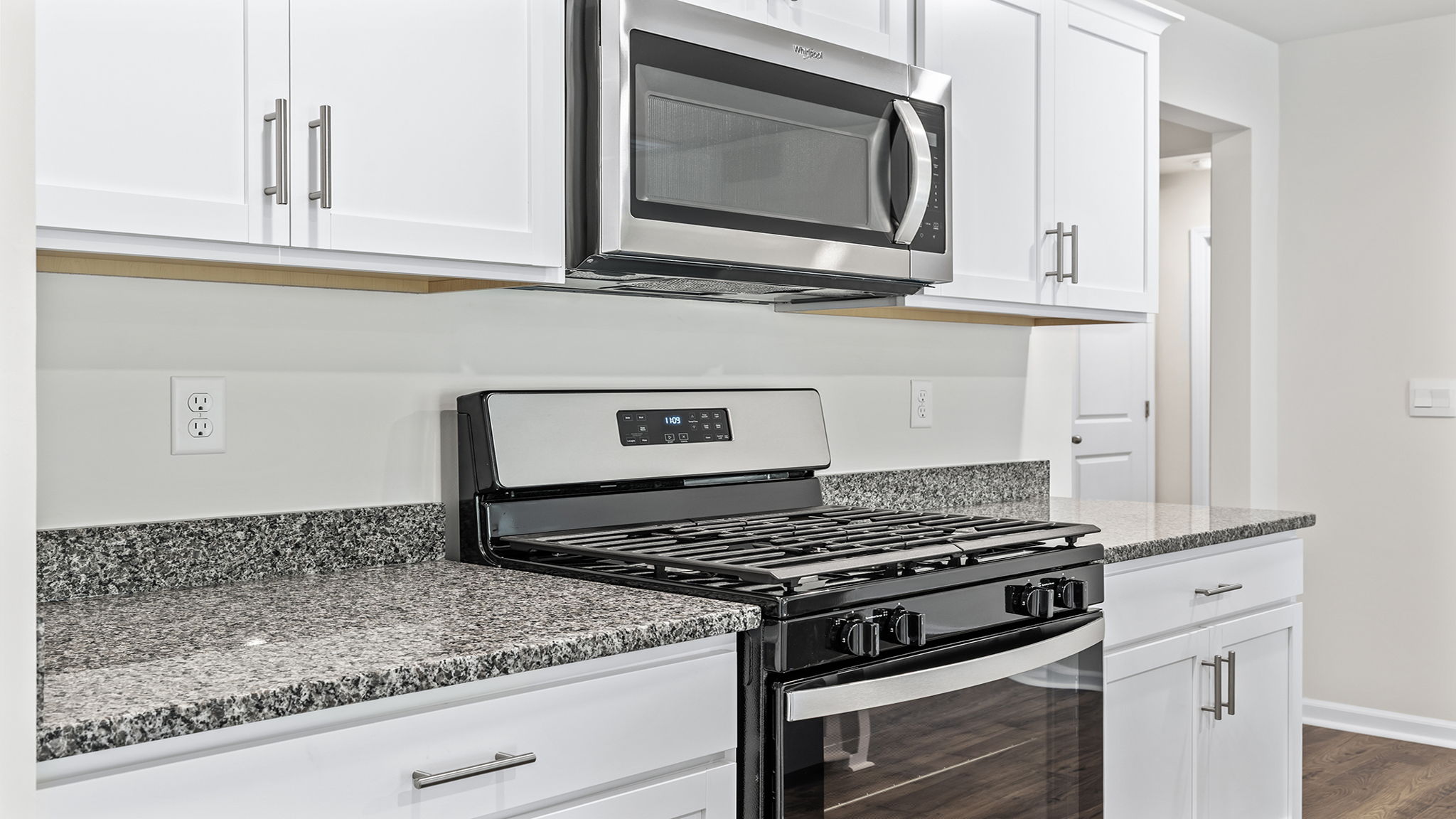 Kitchen with quartz countertops and stainless steel appliances.