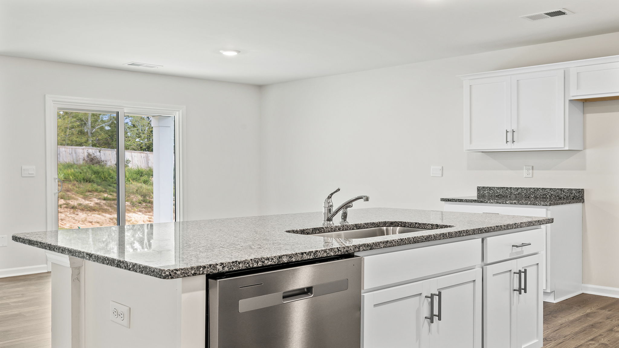 Kitchen with quartz countertops and stainless steel appliances.
