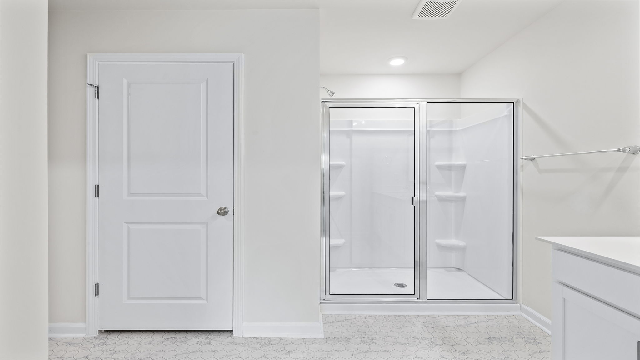 Bathroom with double vanity sink and walk in shower.