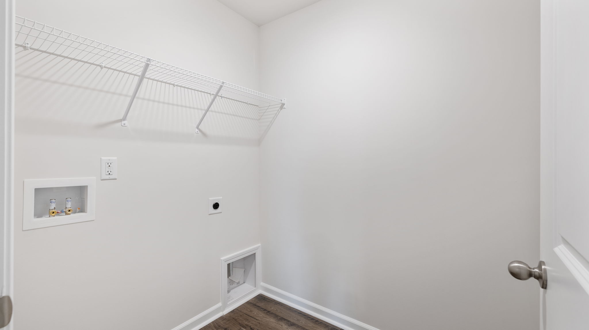 Laundry room with hanging storage racks.