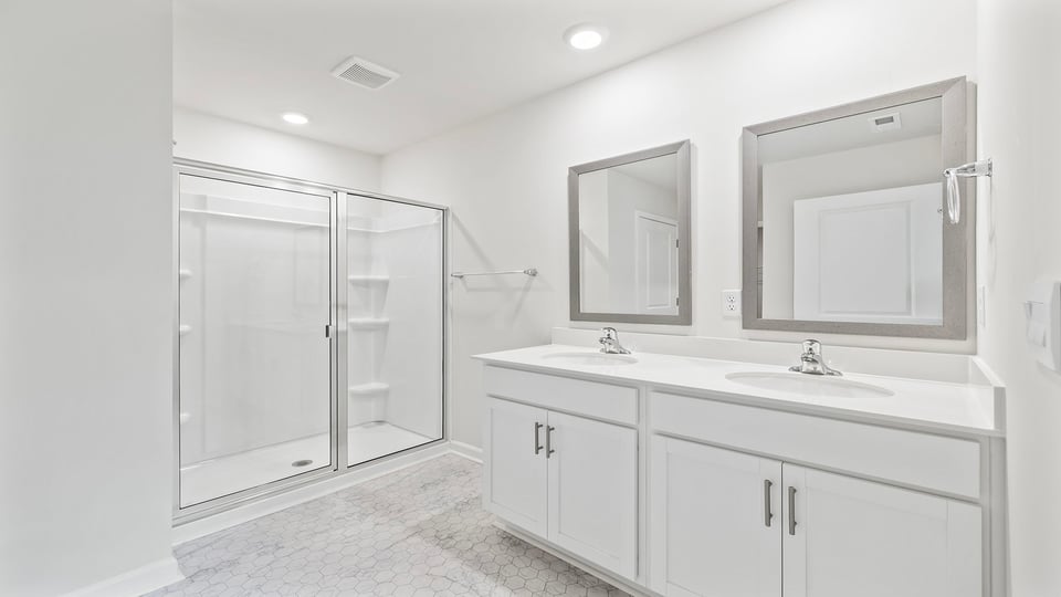 Bathroom with vanity and walk in shower.