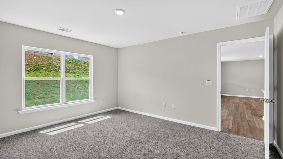 Bedroom with carpet and window.