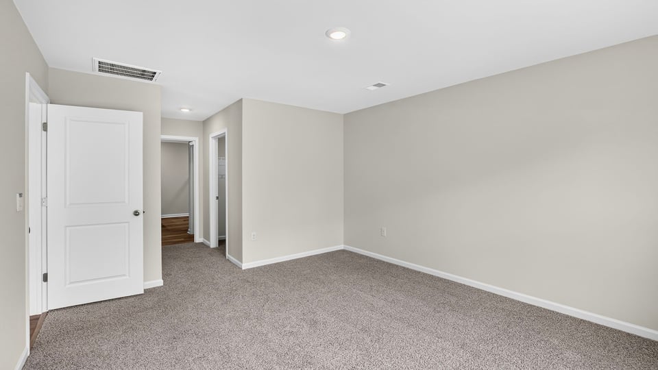 Bedroom with carpet and window.