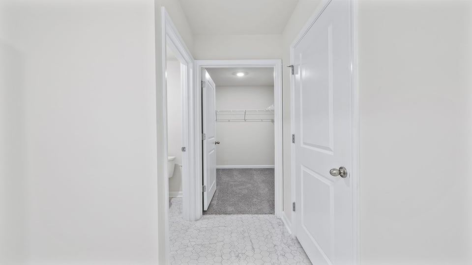 Bathroom with double vanity and walk in shower.