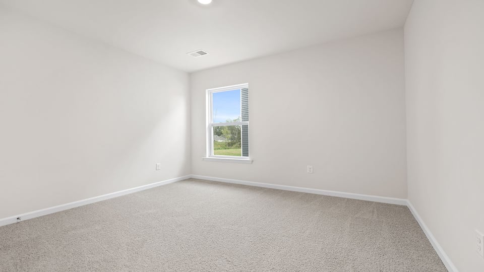 Bedroom with carpet and window.