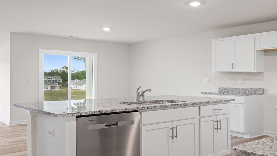 Kitchen and island with granite countertops.