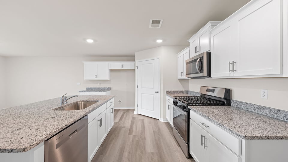 Kitchen and island with granite countertops.