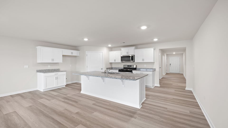 Kitchen and island with granite countertops.