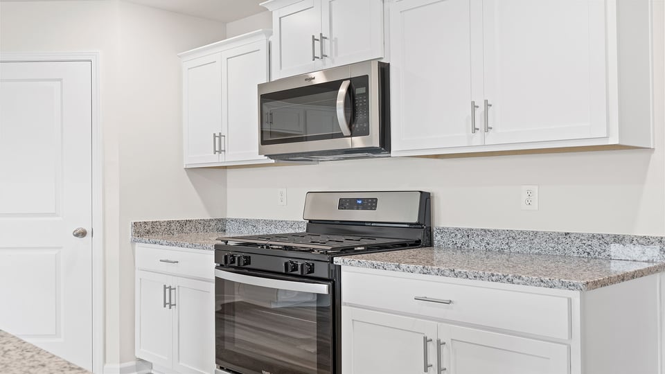 Kitchen with granite countertops and stainless steel appliances.
