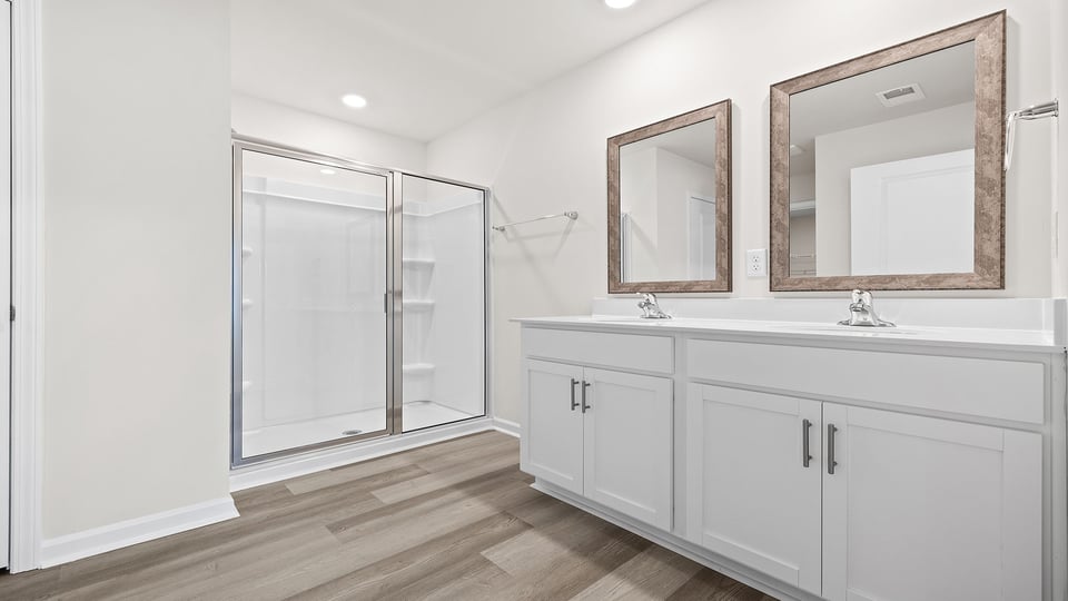 Bathroom with vanity and walk in shower.