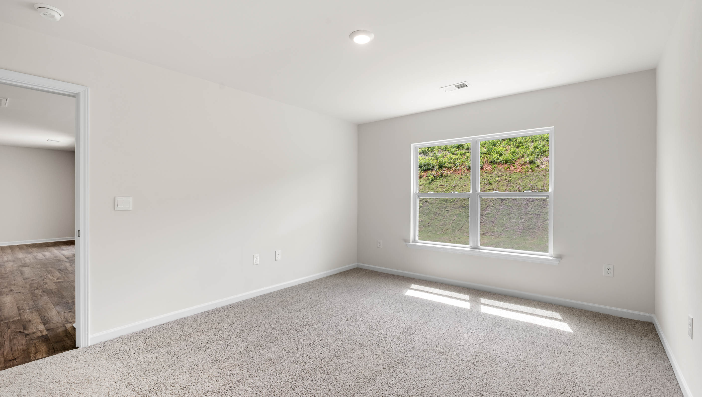 Bedroom with carpet and window.