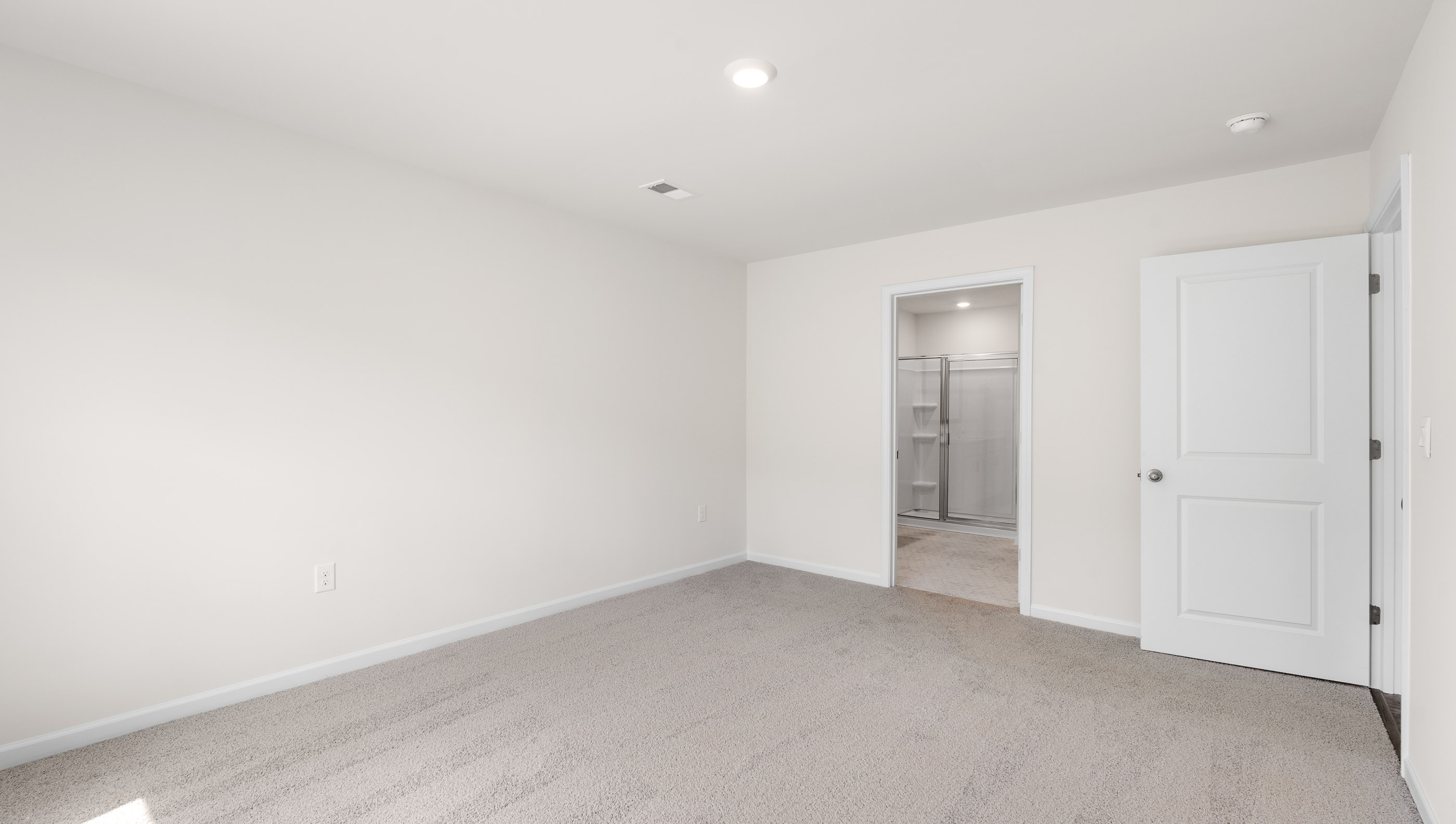 Bedroom with carpet and window.