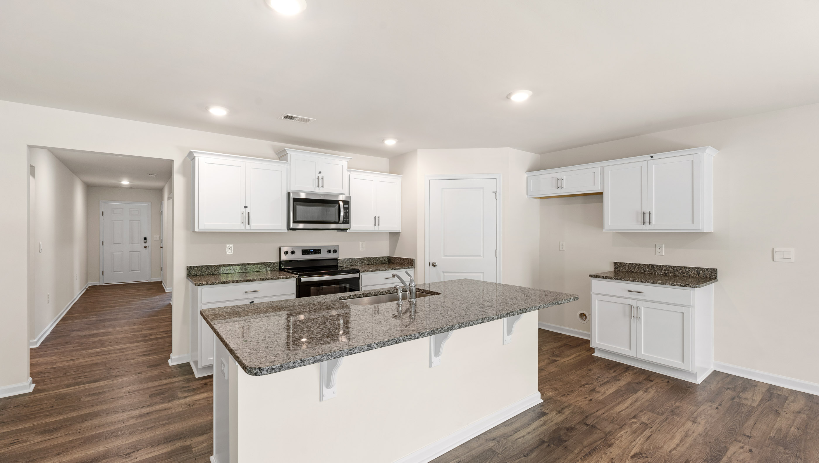 Kitchen and island with granite counter tops.
