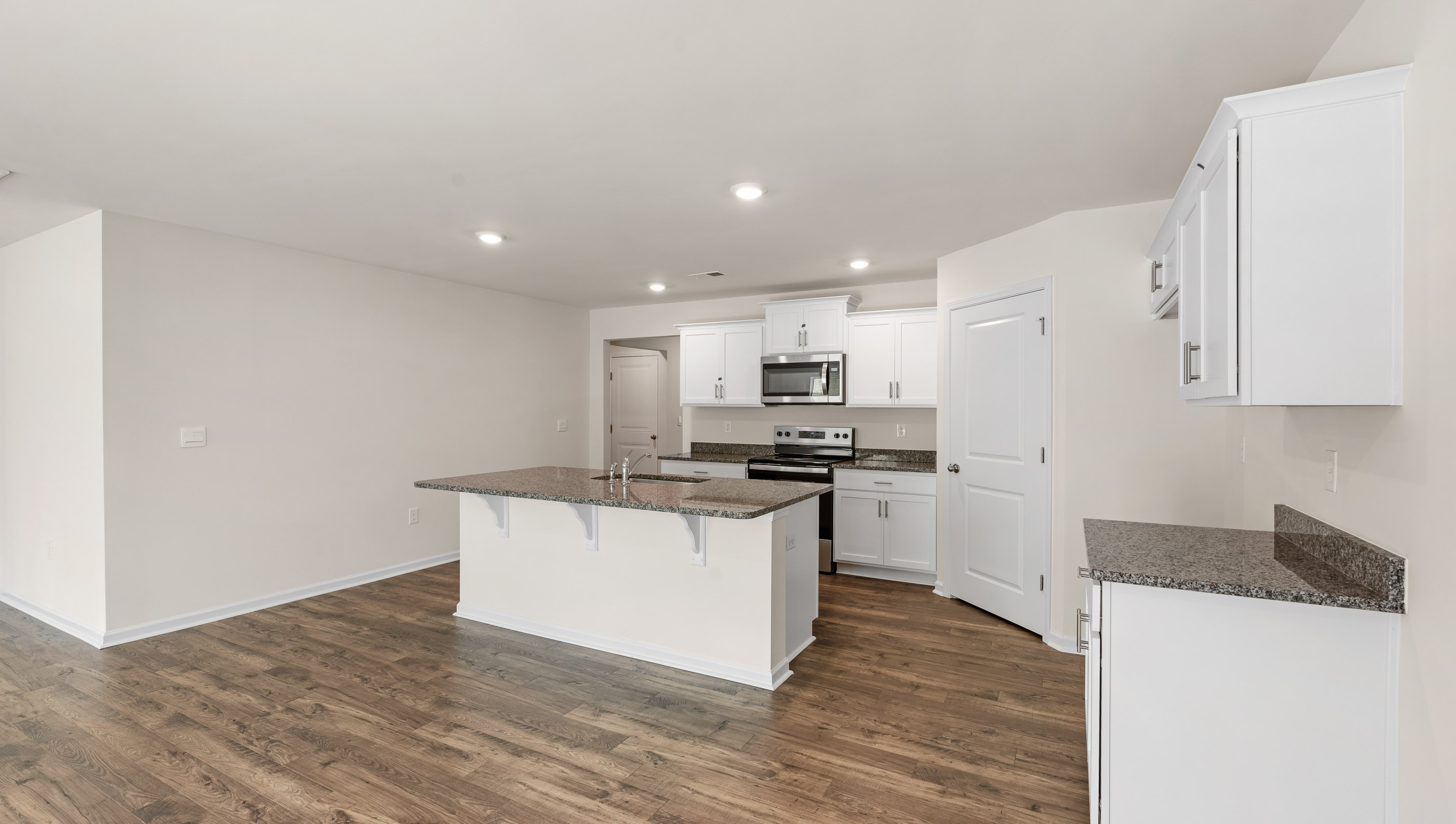 Kitchen and island with granite counter tops.