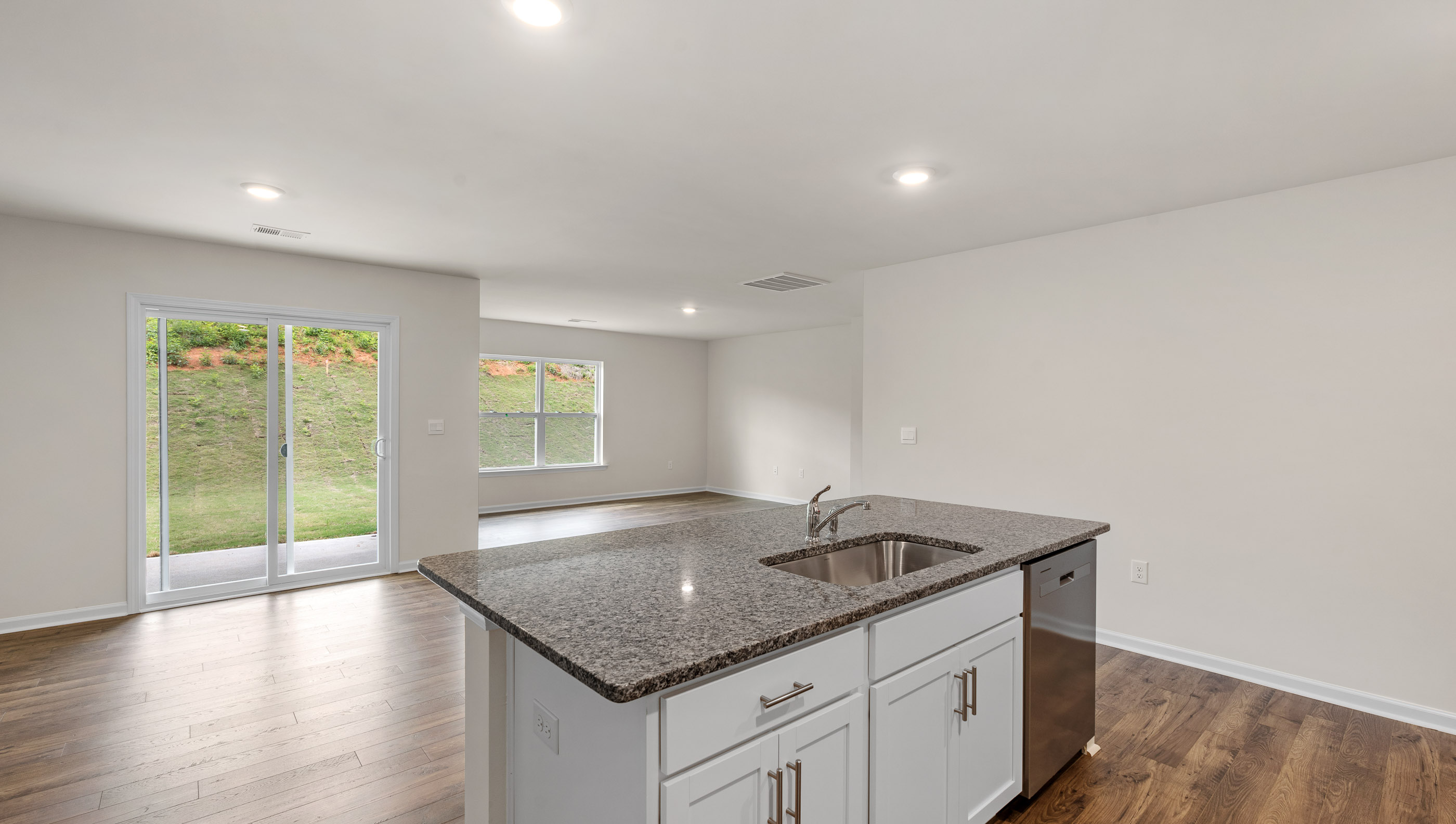 Kitchen and island with granite counter tops.