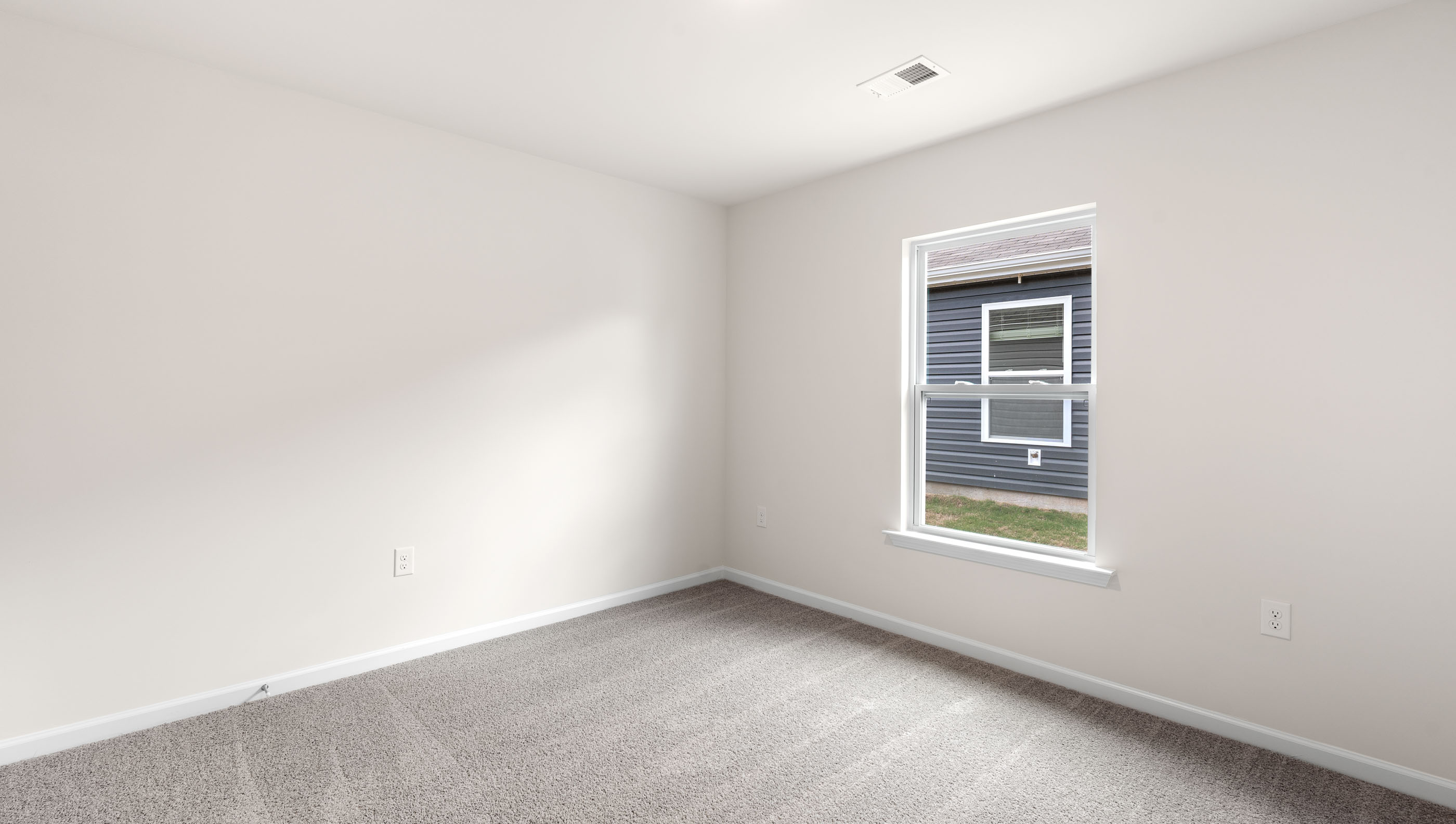Bedroom with carpet and window.