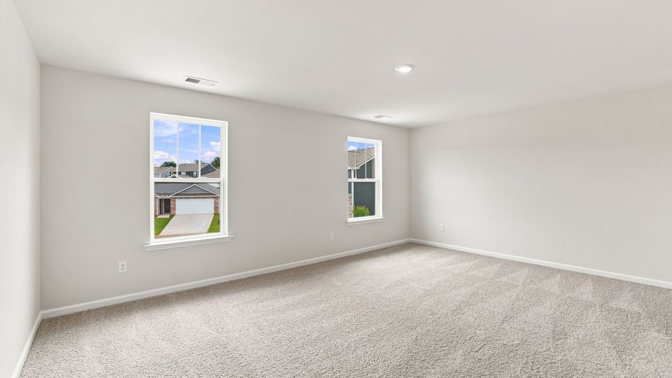 Bedroom with carpet and window.