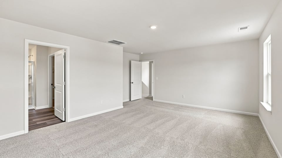 Bedroom with carpet and window.