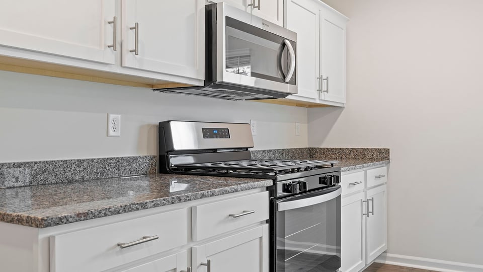 Kitchen with island and granite countertops.