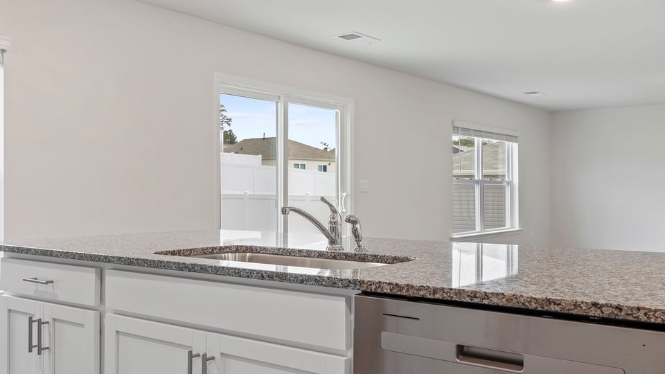 Kitchen with island and granite countertops.