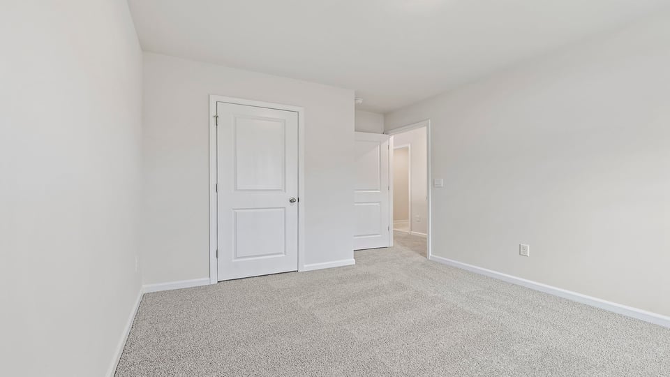 Bedroom with carpet and window.