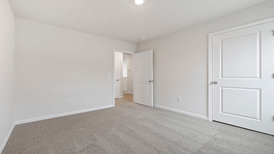 Bedroom with carpet and window.