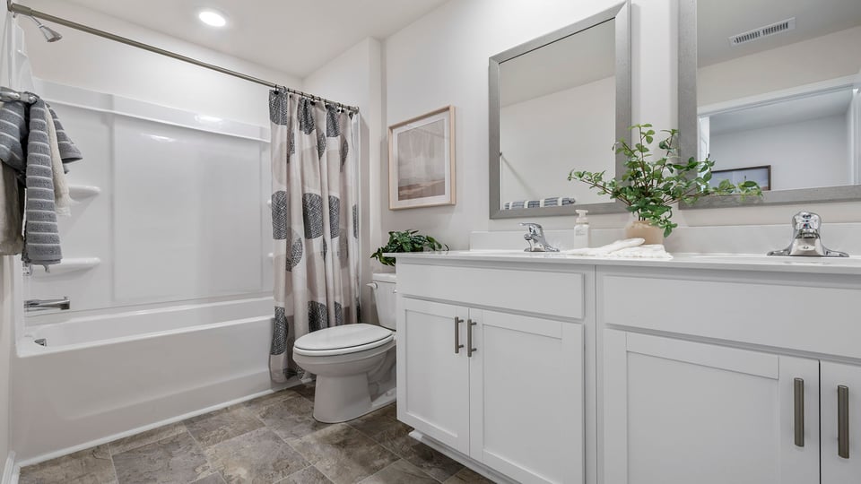 Bathroom with double vanity and tub.