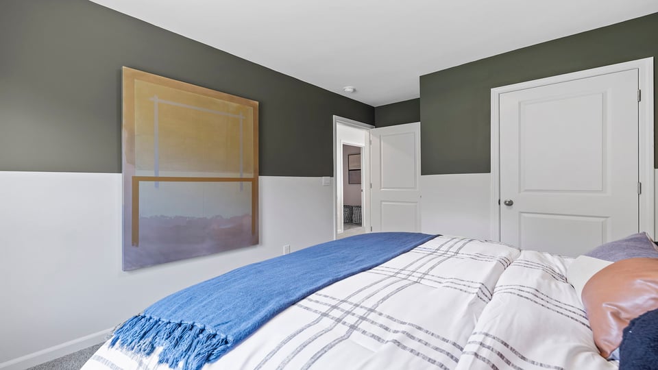 Bedroom with carpet and windows.